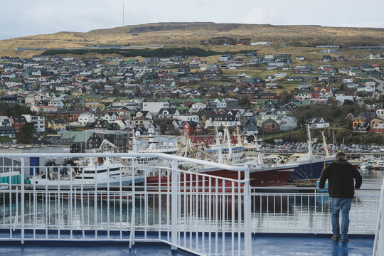 Panoramic scenic coastal view over Thorshavn, Faroe Island city skyline and other rocky isles with lush green meadows Danish  territory in Atlantic Ocean seen from cruiseship cruise ship liner