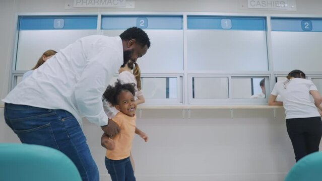 African American family patient walk through corridor in hospital ward. 