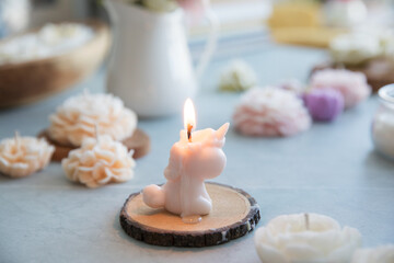 Candle in the shape of a unicorn in the interior