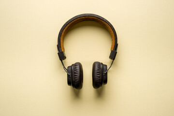 Retro style wireless over-ear headphones on yellow background