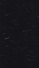 Handmade rice black paper texture with blue fibers for scrapbook.