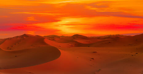 Fototapeta na wymiar Sand dunes in the Sahara Desert at amazing sunrise, Merzouga, Morocco - Orange dunes in the desert of Morocco - Sahara desert, Morocco