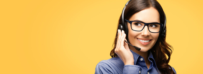 Contact Call Center Service. Customer support, sales agent. Caller answer phone operator businesswoman in headset. Portrait of woman wear glass spectacles. Isolated yellow wall background. Wide banner