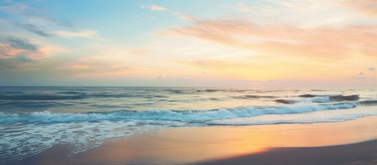 Fototapeta premium Serenity at the Seashore: Majestic Sunset Casting Golden Glow over Gentle Waves