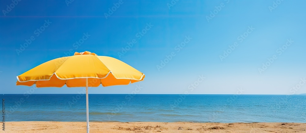 Canvas Prints Vibrant Sunset Setting Behind a Colorful Beach Umbrella with a Serene Ocean View