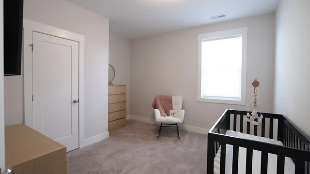Empty Baby's Room With A Crib And Cute Carpet On The Floor. Large Window In The Room, Slow Motion.