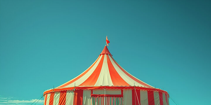 Circus on a sunny summer day A large red and yellow circus tent on blue sky background Happy fiesta fun carnival party
