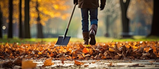 Person Strolling in a Serene Park Environment with a Broom for Cleaning