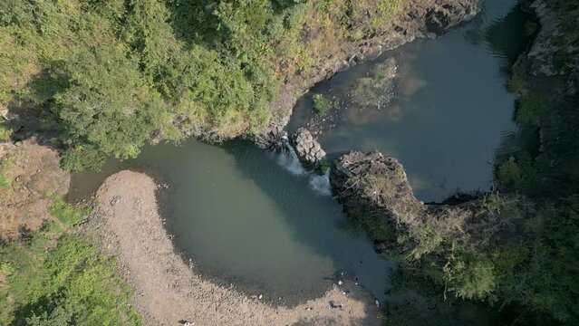 Stunning Vuc Hom Waterfalls nestled in pristine tropical setting surrounded by rainforest in Vietnam's Phu Yen province