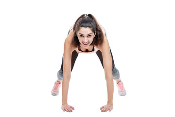 Smiling young woman in sportswear doing exercises. Beautiful brunette in a pink top. Activity, energy and health. Isolated on a white background.