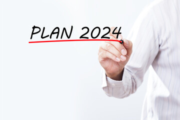 Businessman hand writing plan 2024 with red marker on transparent wipe board, business concept