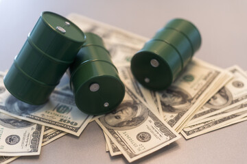 Barrel of crude oil with dollar bills. Close up. Business concept.
