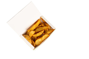 fried potato wedges in a white carton box isolated on white background. Top view. baked potatoes wedges in a paper wrapper .takeaway food concept, street food.