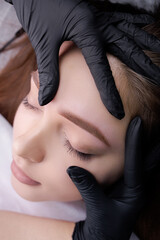 Close-up demonstration of permanent makeup after eyebrow design procedure. PMU Procedure, Permanent...