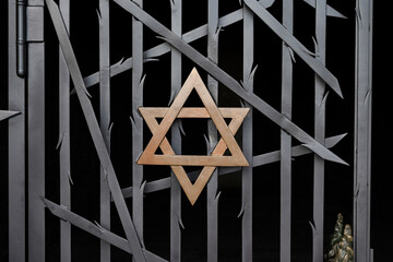 A jewish Star of David, made of golden metal on a black metal fence Dachau - 752818192