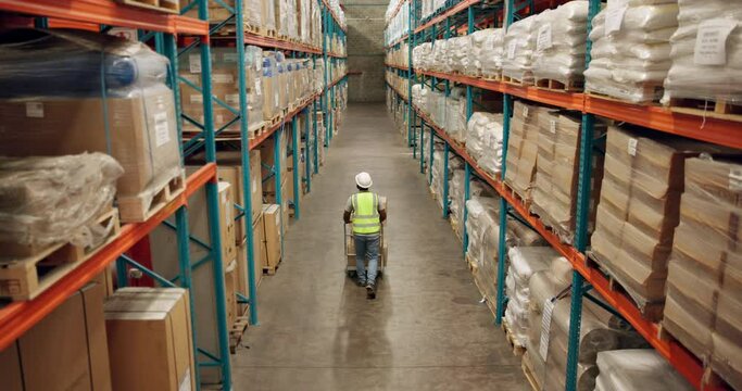 Warehouse, shipping and man walking in a distribution, freight and supply chain company. Worker, contractor and back with stock, factory and export business with employee working with storage