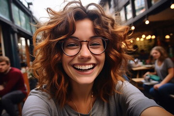 Portrait of laughing happy joyful satisfied curly hairstyle woman wearing glasses outdoors - obrazy, fototapety, plakaty