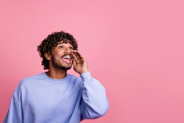 Fototapeta na wymiar Photo of cheerful glad man wear blue trendy clothes look empty space announce special offer proposition isolated on pink color background