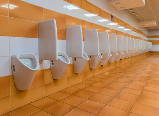 Long row of urinals in a public toilet