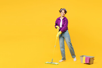 Full body young woman wearing purple shirt casual clothes do housework tidy up hold in hand mop...