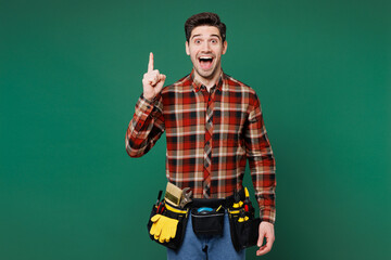 Young employee laborer handyman man wear red shirt hold index finger up great new idea isolated on...
