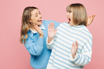 Elder amazed parent mom with young adult daughter two women together wear blue casual clothes open eyes with hands play guess who or hide and seek isolated on plain pink background Family day concept