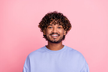 Fototapeta premium Photo of cheerful glad bearded man toothy smile afro curls dressed blue trendy clothes isolated on pink color background