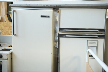 Old refrigerators in a landfill. Recycling of household appliances.
