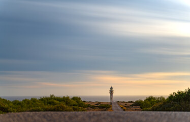 Solitary Lighthouse Road at Sunset, Formentera with Silky Clouds and Sea