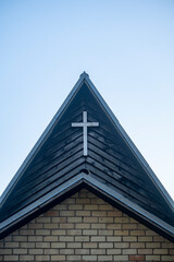 Fototapeta na wymiar modern Christian church roof top with cross