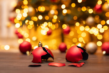 Broken christmas tree ball decoration on the floor. Broken decoration, christmas tree in brights...