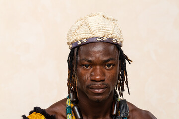 traditional african man with cowrie shell headband and necklace