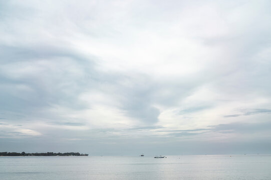 Soft Sky and Calm Sea with Distant Boats, Gili Island, Indonesia, Asia