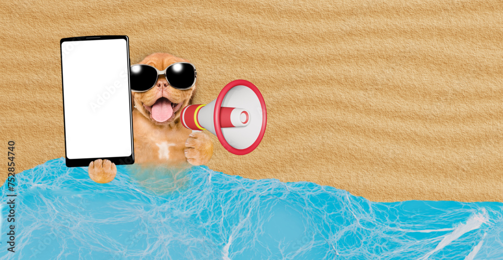 Poster Happy Mastiff mastiff puppy lying at sunny beach and showing big smartphone with white blank screen in it paw and screaming into a megaphone. Empty space for text