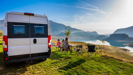 Campervan, Motorhome RV parked next to the lake or river in Bosnia and Herzegovina. Family with...