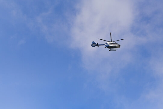 helicopter flying in the blue sky
