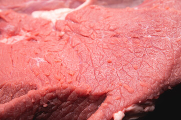 Raw large premium steak. Raw fresh premium beef in shallow depth of field