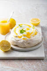 Traditional Pavlova dessert with lemon curd