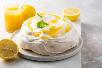 Traditional Pavlova dessert with lemon curd