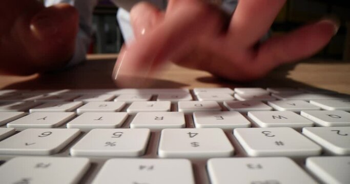 Woman types fast on computer keyboard working from home