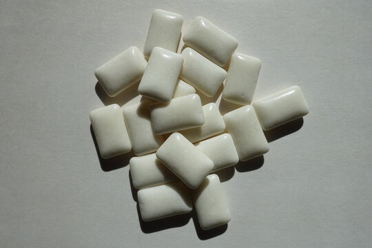 Heap of white rectangular pieces of chewing gum from above