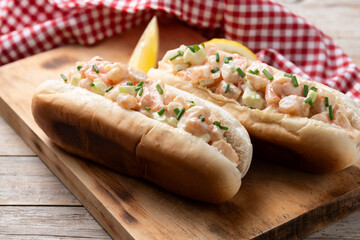 Traditional lobster roll on wooden table