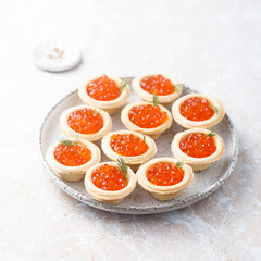Red caviar served in tartlets
