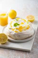 Traditional Pavlova dessert with lemon curd