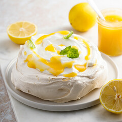 Traditional Pavlova dessert with lemon curd