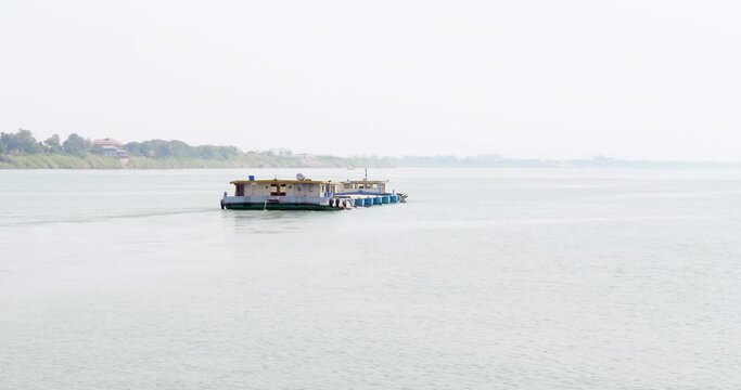 back view of a sand barge is used to transport sand on the river 