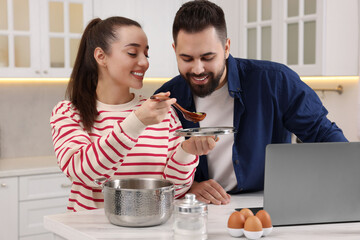 Happy lovely couple cooking together in kitchen