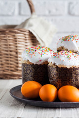 Decorated Easter cakes and yellow colored eggs on a plate.