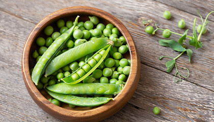 Cloce-up view of Hearthy fresh green peas and pods in wooden bowl on rustic background