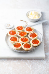 Red caviar served in tartlets